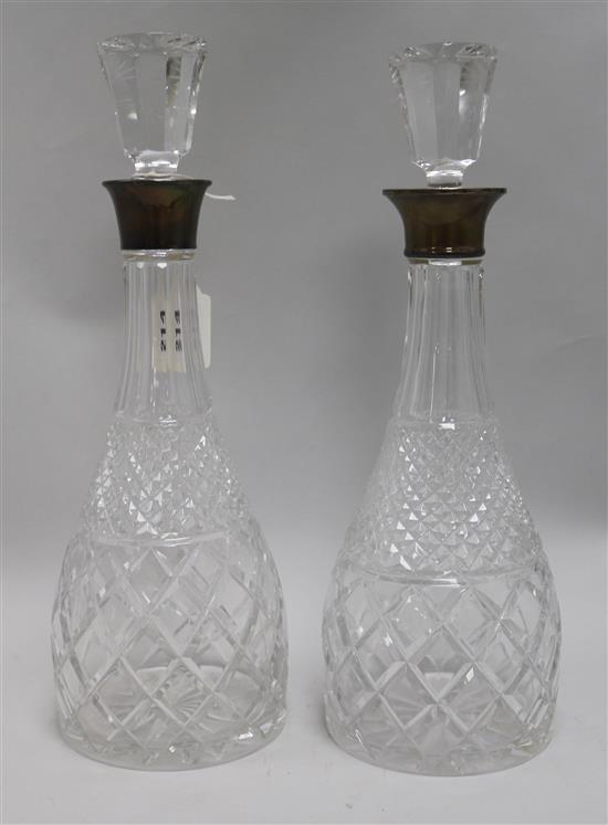 A pair of silver collared decanters